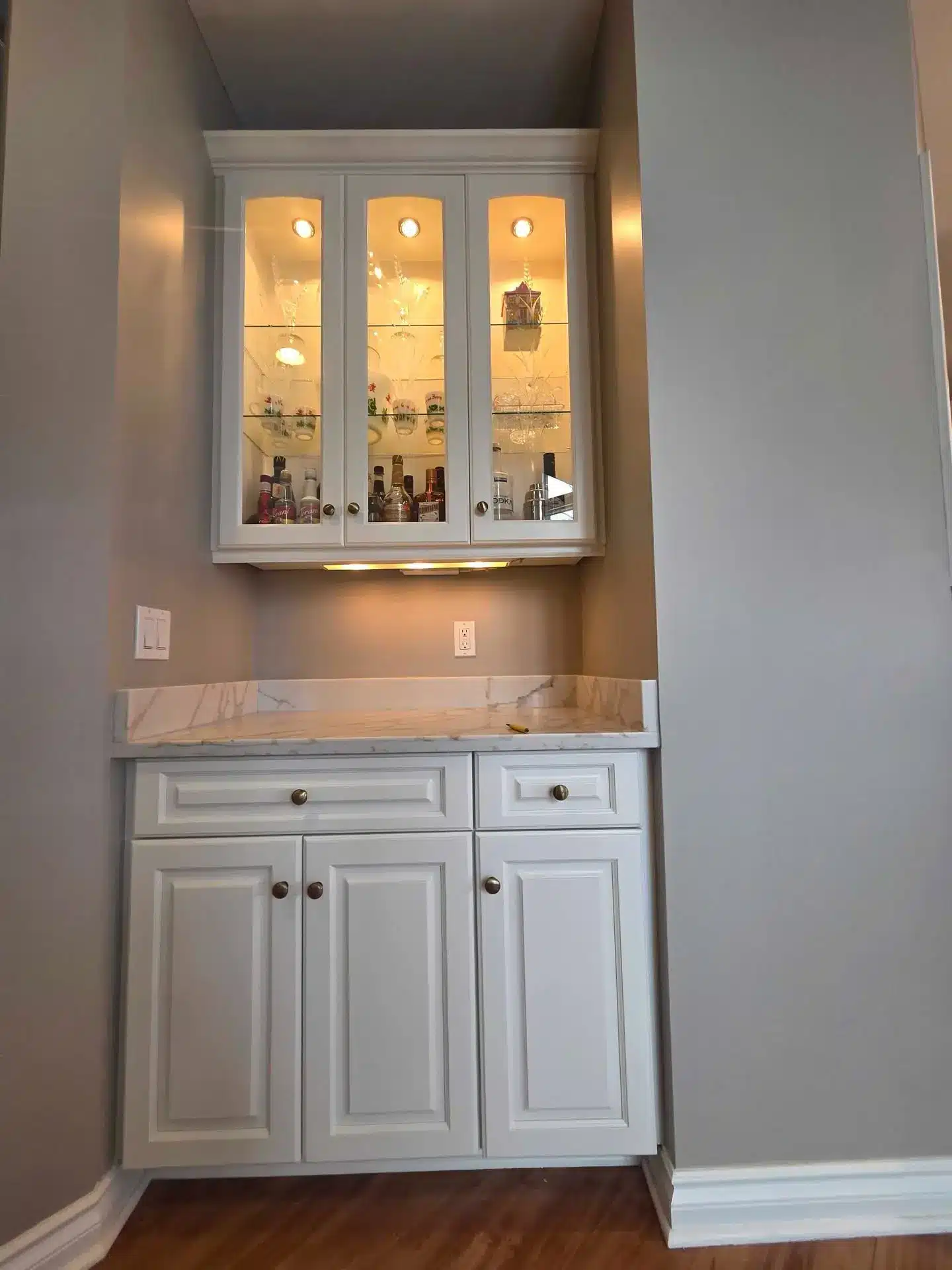 Complete cabinet refinishing featuring white painted cabinetry and stainless steel appliances