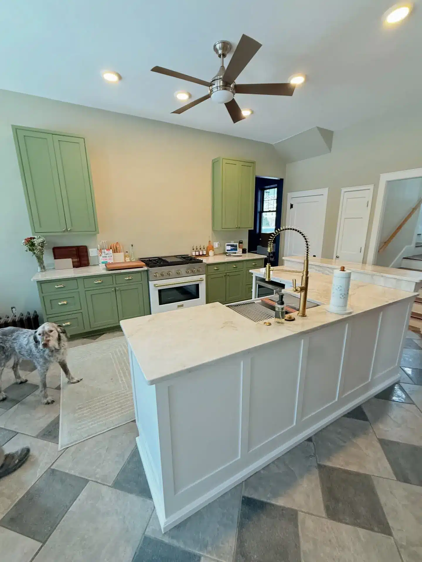 Refinished white kitchen cabinets with brick backsplash and granite counters